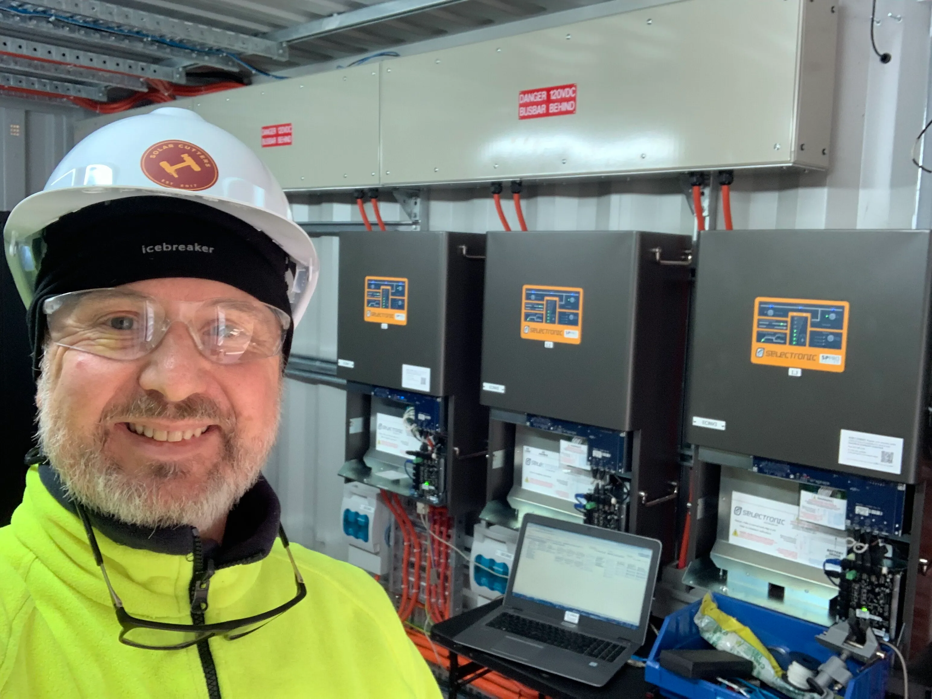Glen Morris on site at Upper Yarra Dam, beside the containerised battery/inverter system